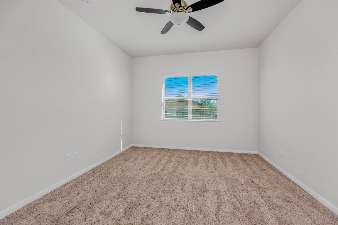 9941 Comely Bend Manor, TX 78653 - Photo 24 of 31 an empty room with a window and a fan