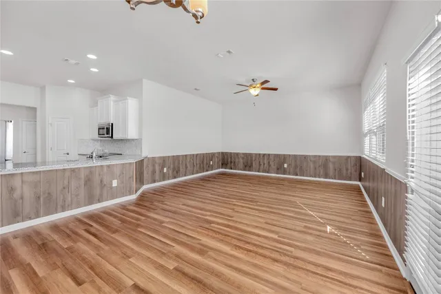 a view of kitchen and hall with wooden floor