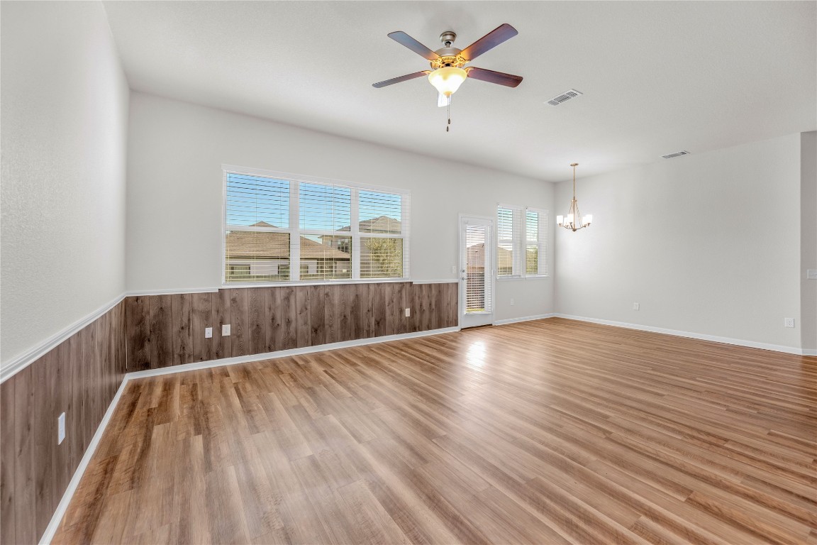 9941 Comely Bend Manor, TX 78653 - Photo 27 of 31 wooden floor in an empty room with a window