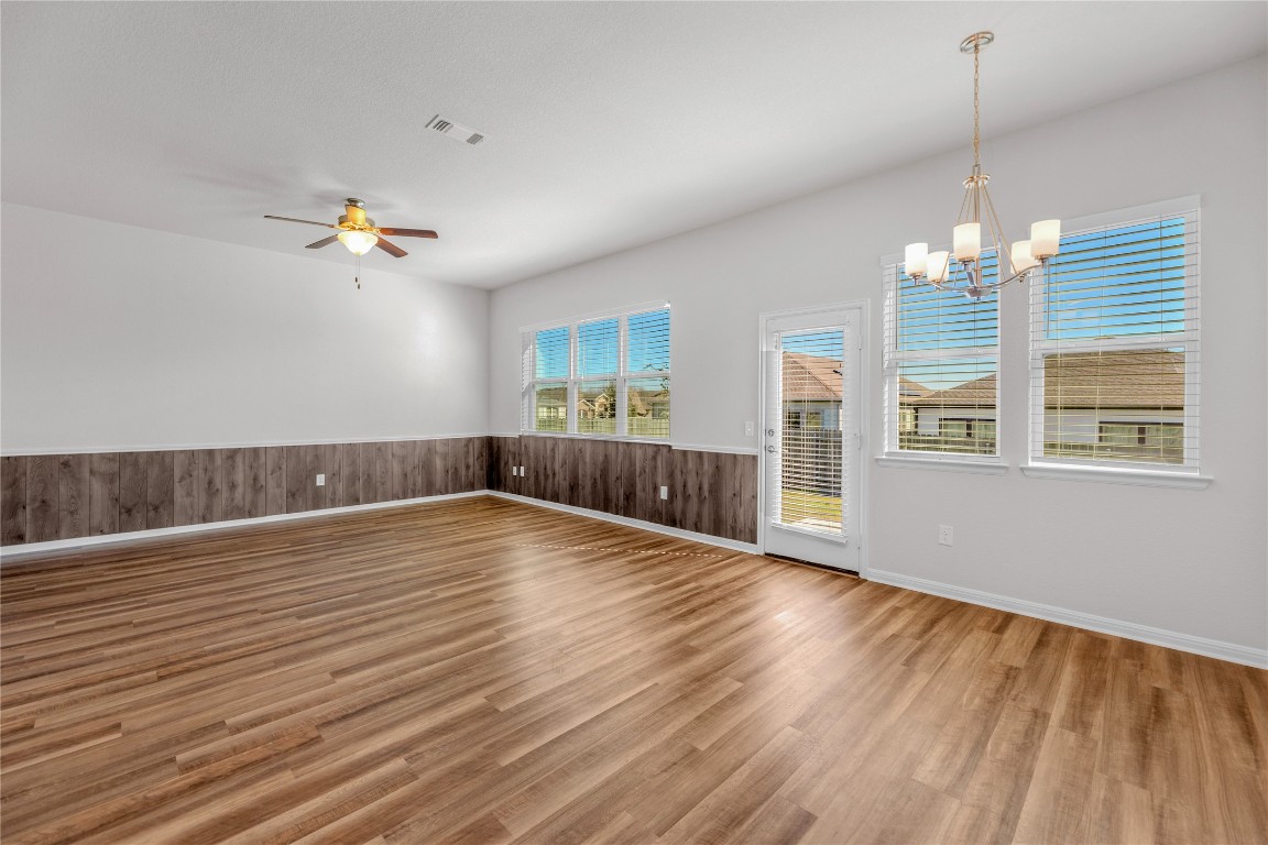 9941 Comely Bend Manor, TX 78653 - Photo 28 of 31 a view of an empty room with wooden floor and a window
