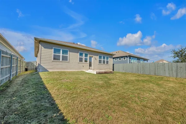 a view of a house with a backyard