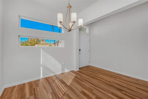 a view of a hallway to a bedroom with wooden floor
