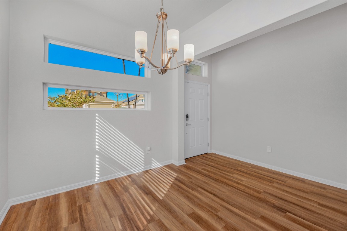 9941 Comely Bend Manor, TX 78653 - Photo 4 of 31 a view of a hallway to a bedroom with wooden floor