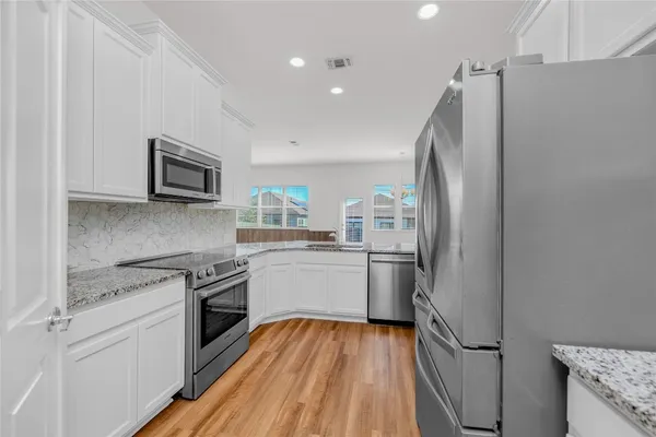 a kitchen with a refrigerator stove and sink