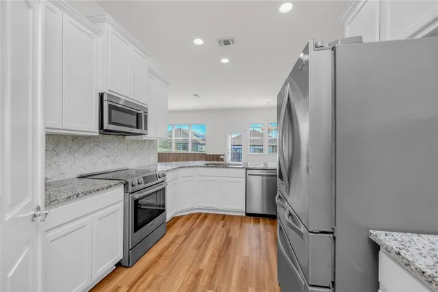 a kitchen with a refrigerator stove and sink