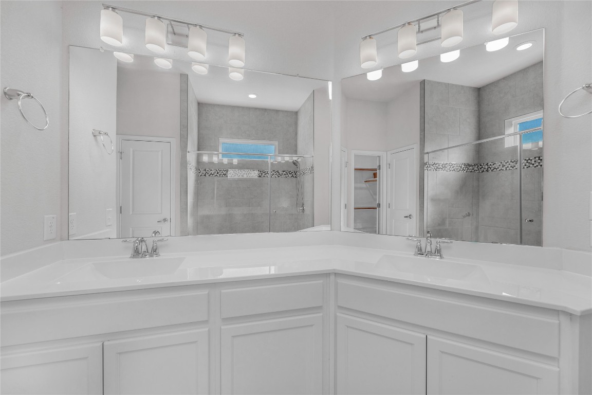 9941 Comely Bend Manor, TX 78653 - Photo 10 of 31 a bathroom with a sink shower and a mirror