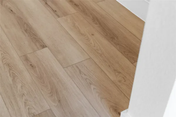 a large kitchen with stainless steel appliances kitchen island a large counter top and a wooden floors