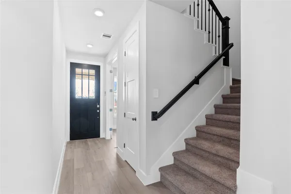 a large kitchen with kitchen island a large counter top stainless steel appliances and cabinets