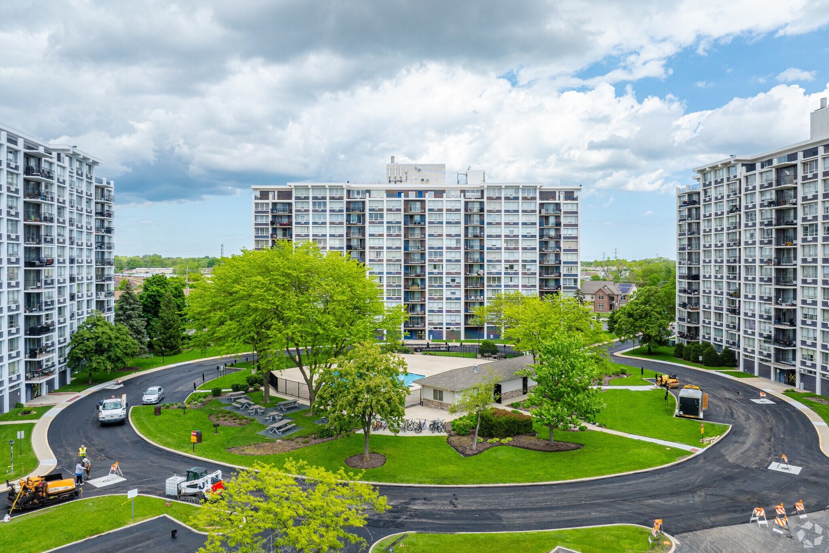 8809 Golf Road, Unit 10C Niles, IL 60714 - Photo 2 of 6 a view of a swimming pool in front of buildings