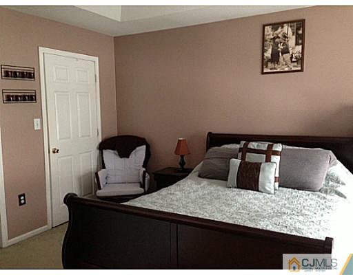 1806 Ridgeview Court Sayreville, NJ 08859 - Photo 4 of 7 a bedroom with bed and night stand