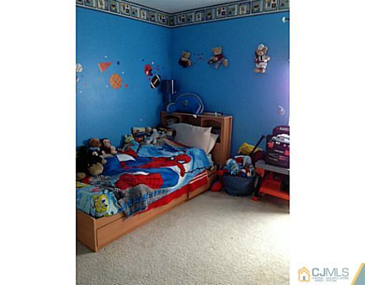 1806 Ridgeview Court Sayreville, NJ 08859 - Photo 6 of 7 a bedroom with bed and a couch