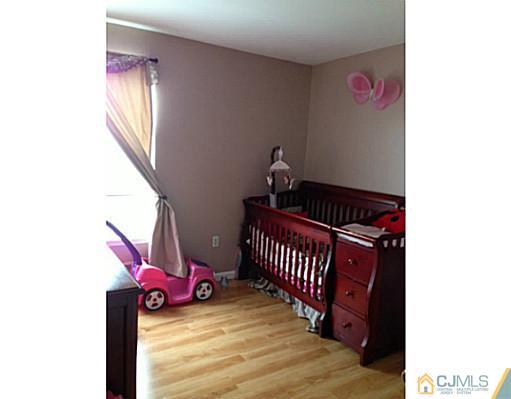 1806 Ridgeview Court Sayreville, NJ 08859 - Photo 7 of 7 a bedroom with a bed and wooden floor