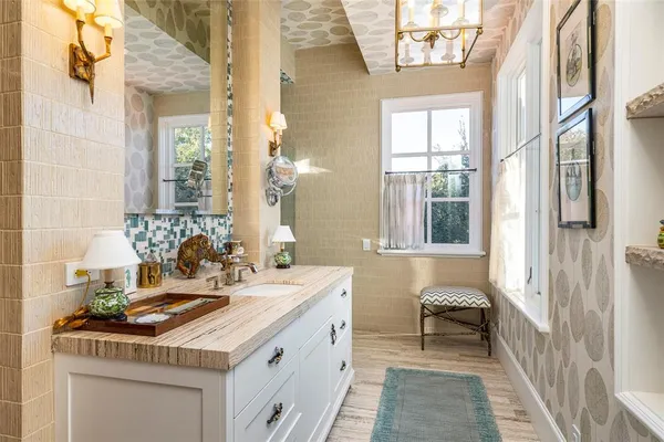 a bathroom with a sink a vanity and a mirror