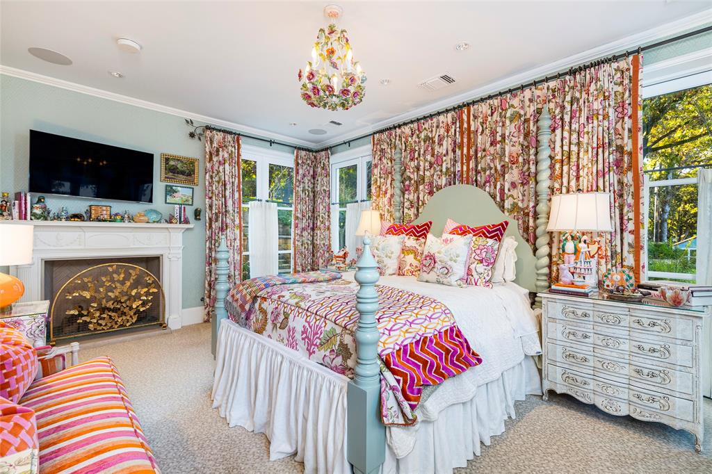 13230 Miller Road Azle, TX 76020 - Photo 18 of 37 a bedroom with a bed a flat screen tv and a fireplace