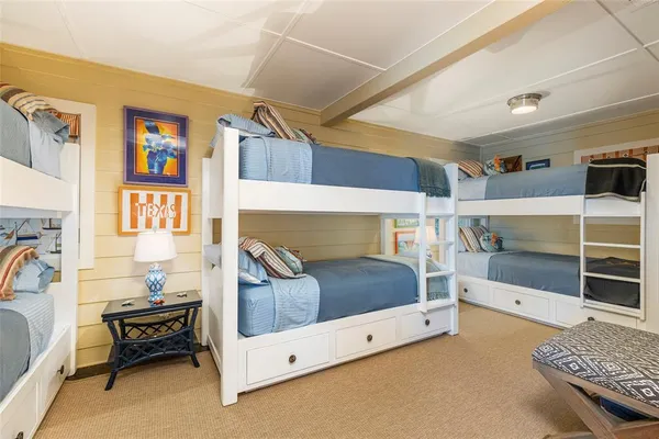 a living room with stainless steel appliances furniture and a rug