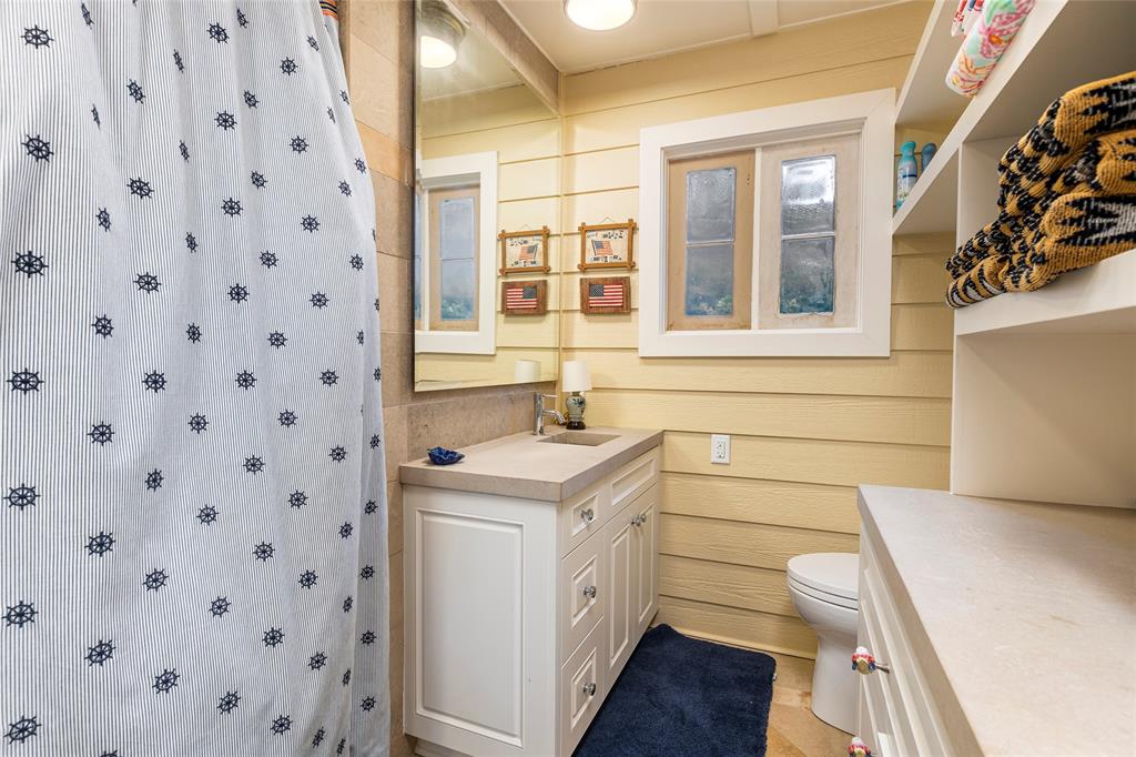 13230 Miller Road Azle, TX 76020 - Photo 32 of 37 a bathroom with a sink a toilet and a shower curtain