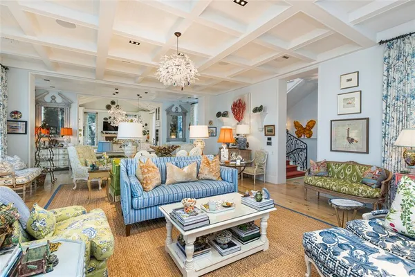 a living room with furniture and a chandelier
