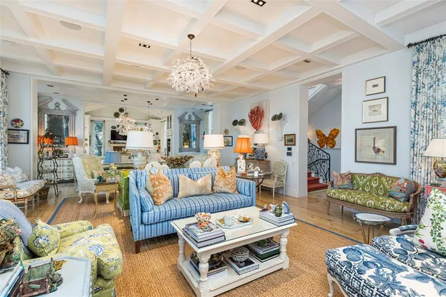 a living room with furniture and a chandelier