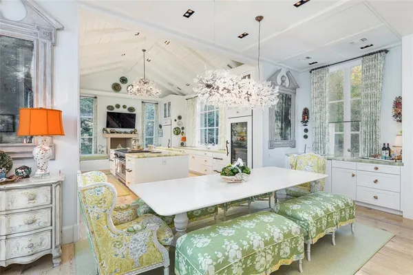 a living room with dining table and a fireplace