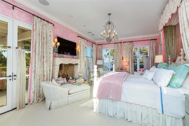 a bedroom with a bed wooden floor and flat screen tv
