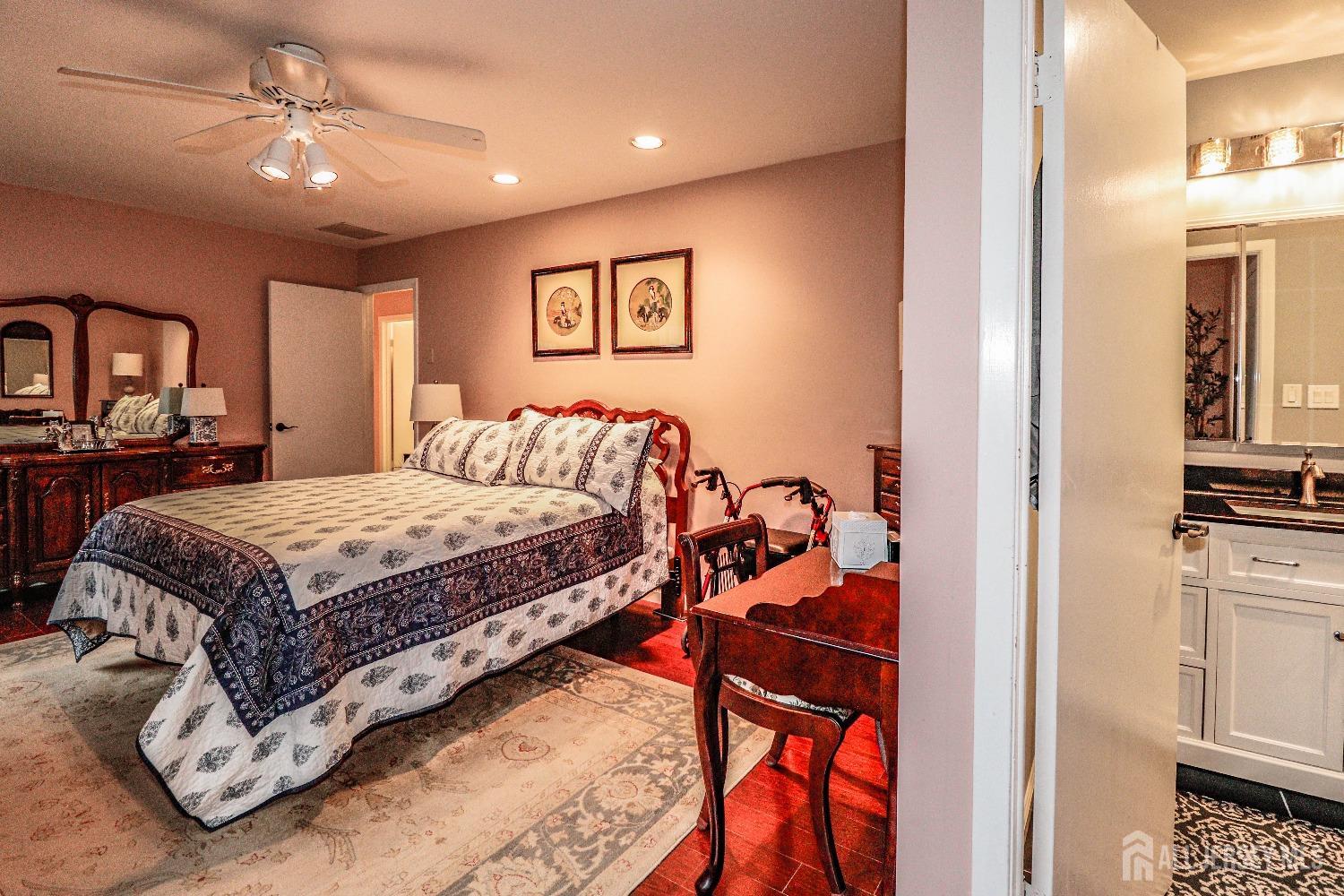 34 Park Gate Drive Edison, NJ 08820 - Photo 27 of 31 a bedroom with a bed and a chandelier