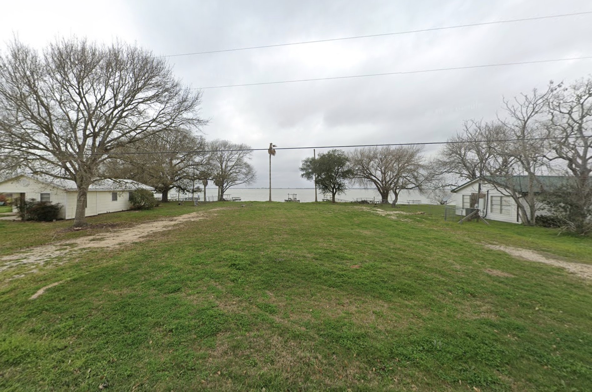 62 Trout Street Palacios, TX 77465 - Photo 2 of 2 a view of a field of grass and trees