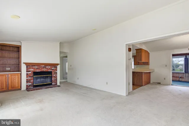 an empty room with furniture and a fireplace