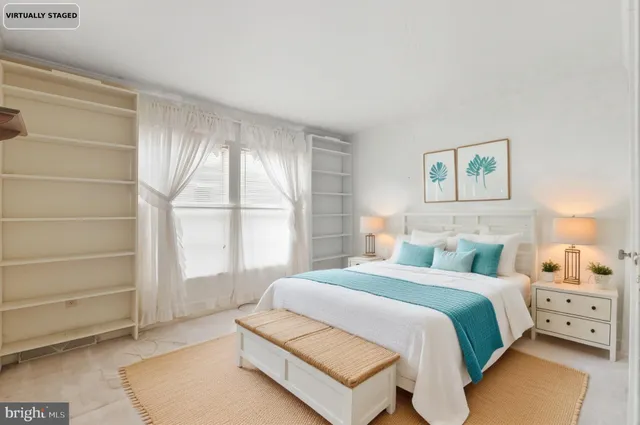 a spacious bedroom with a bed and a window