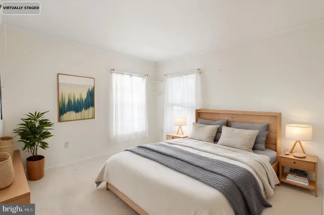 a bedroom with bed and a potted plant