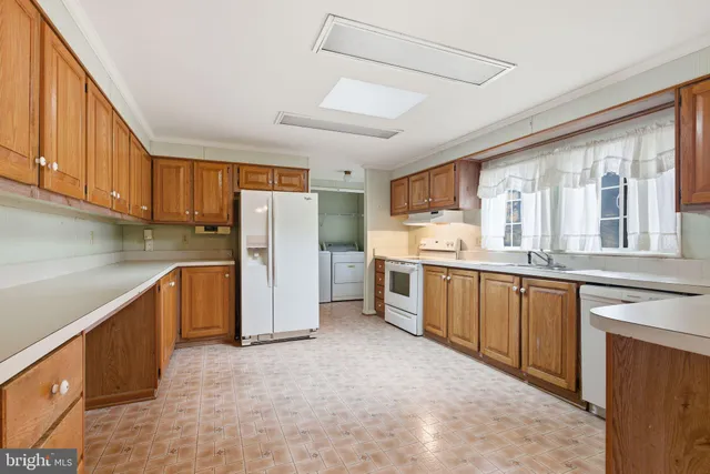 a kitchen with stainless steel appliances granite countertop a refrigerator sink and cabinets