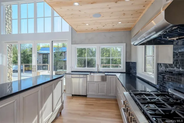 a kitchen with stainless steel appliances a sink and a stove