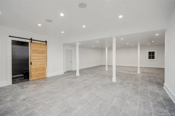 an empty room with closet and a bathroom