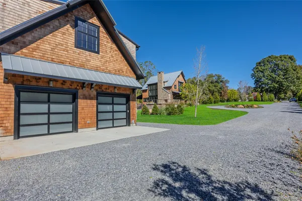 a view of a house with a yard and garage