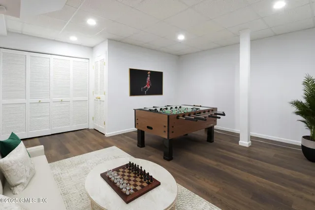 a view of a backyard with furniture and garden