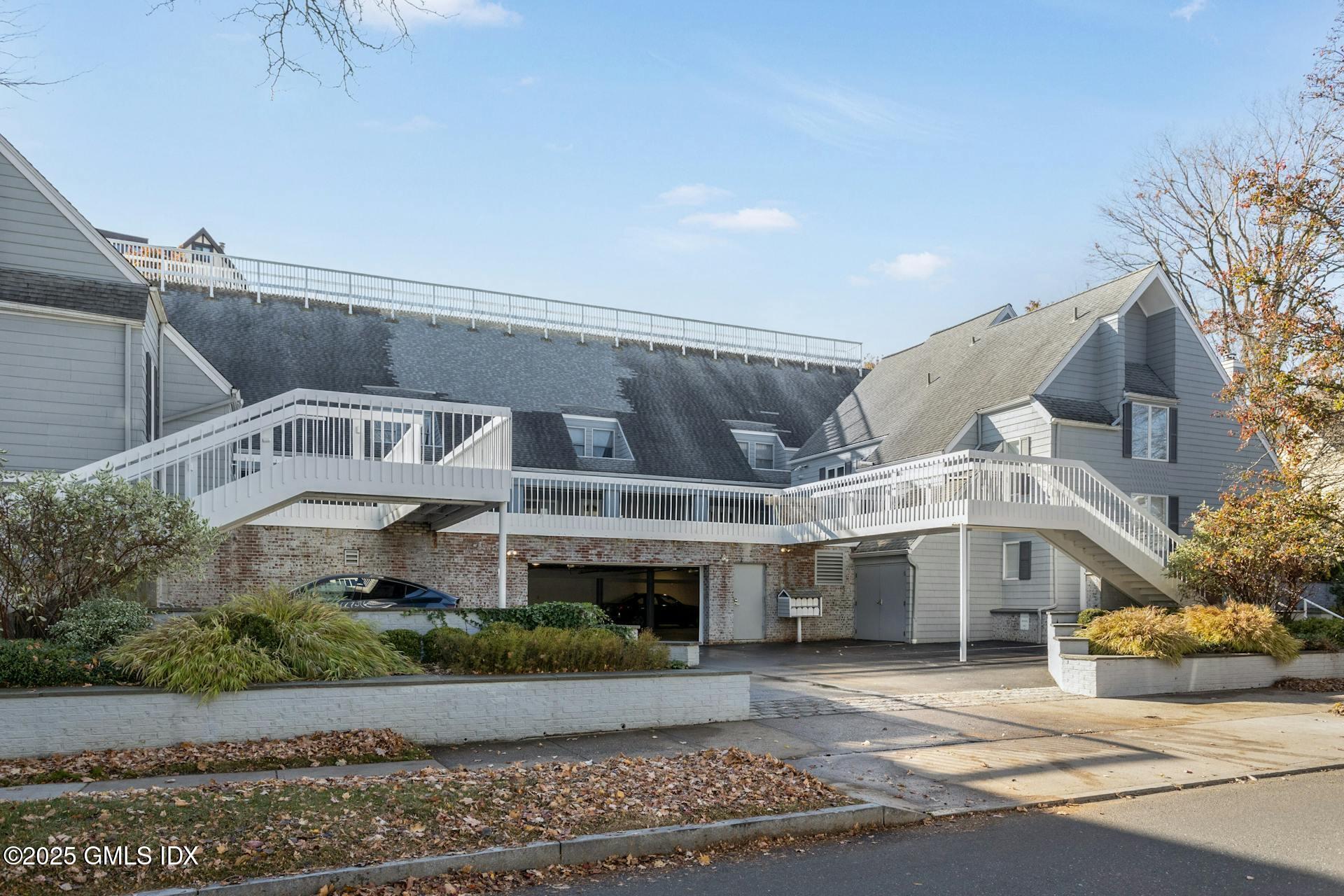 50 Church Street, Unit 5 Greenwich, CT 06830 - Photo 2 of 17 a view of a white building among the street with palm trees