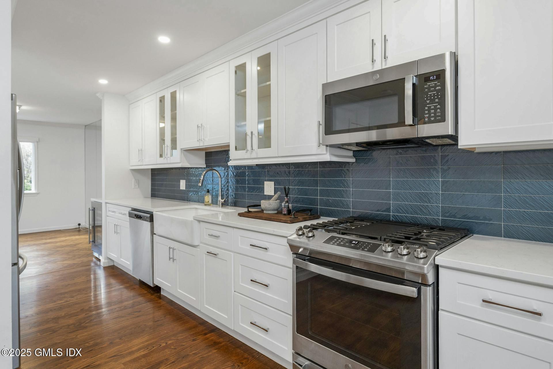 50 Church Street, Unit 5 Greenwich, CT 06830 - Photo 5 of 17 a kitchen with stainless steel appliances granite countertop grey cabinets a stove a sink and dishwasher
