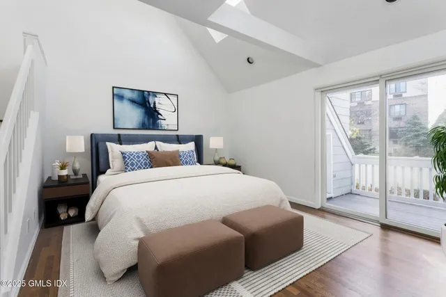 a bedroom with furniture and a rug