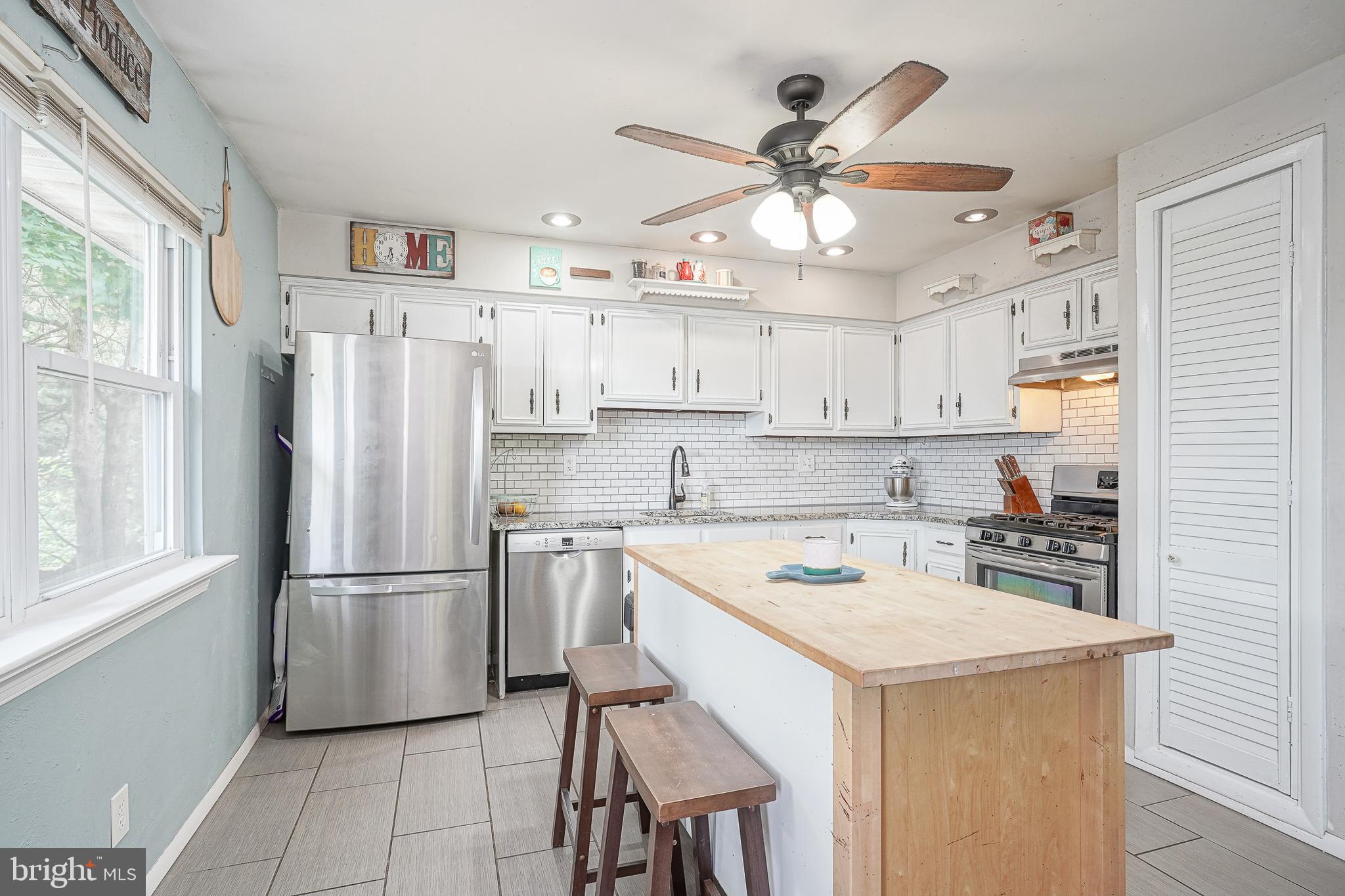 47 Bryant Road Blackwood, NJ 08012 - Photo 6 of 21 a kitchen with a refrigerator a sink cabinets and wooden floor