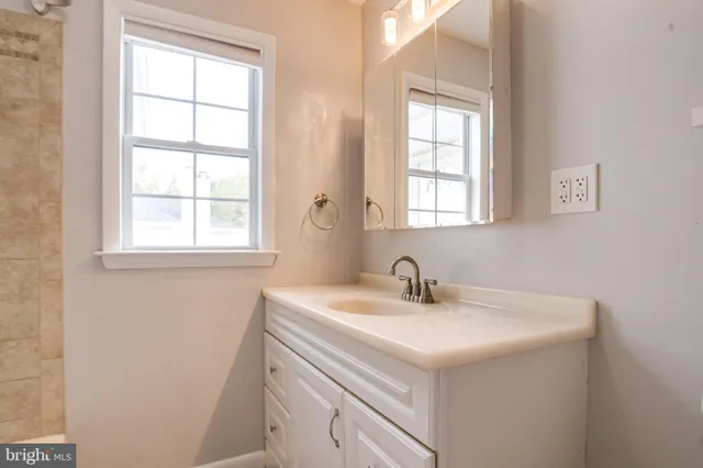 a bathroom with a sink and a window