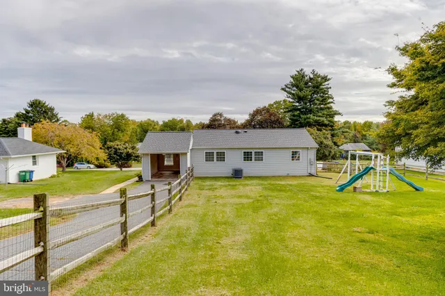 a swimming pool with yard and outdoor seating
