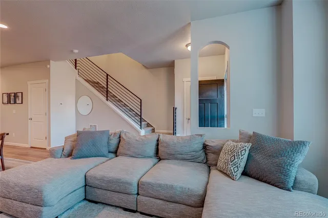 a living room with furniture and a ceiling fan