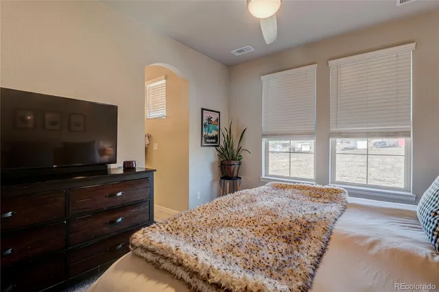a living room with couch cabinet and a flat screen tv