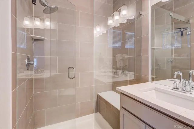 a bathroom with a sink vanity and a mirror