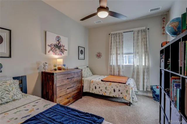 a bedroom with a bed and painting on the wall