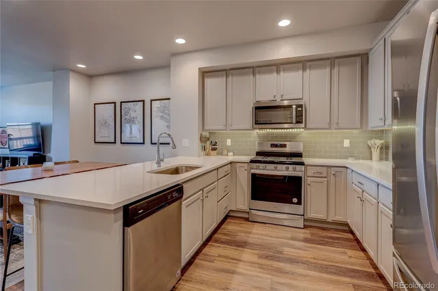 a kitchen with stainless steel appliances granite countertop a stove and a sink