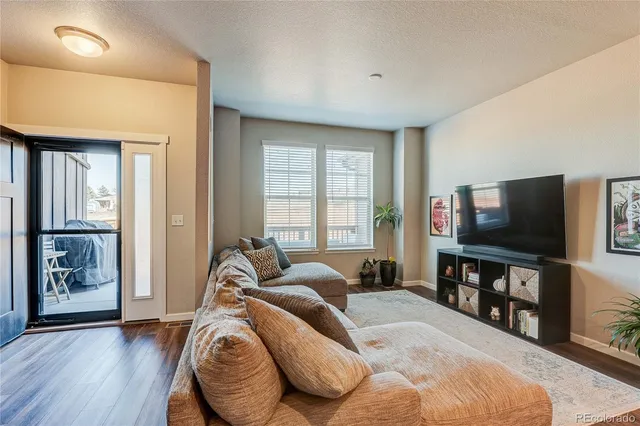 a spacious bedroom with a bed and a flat screen television