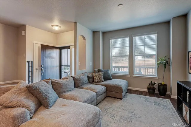 a living room with furniture large windows and a flat screen tv