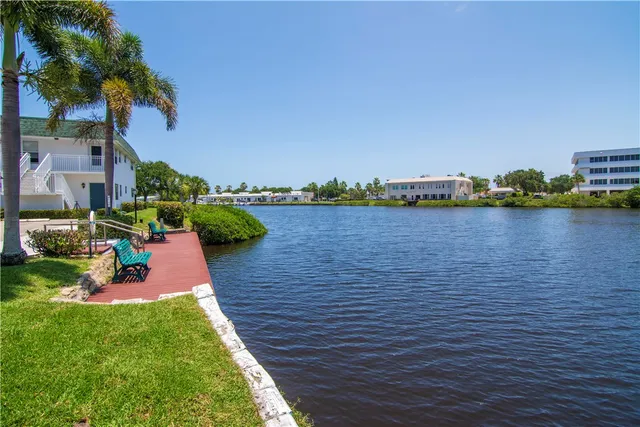 a view of a lake with houses in the back