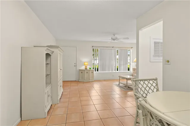 a view of an empty room with cabinet and a window