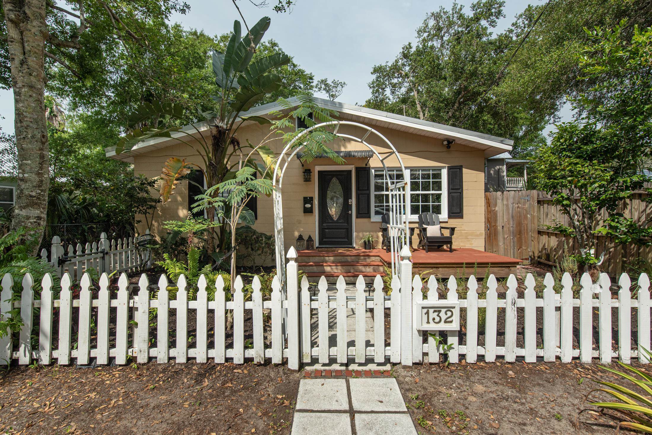 a front view of a house with a garden